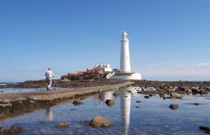 Walk: Coast Exterior of St Mary's Island showing the white lighthouse and surrounding sea/rocks