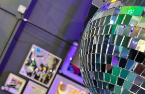 Pretty Urban Exhibition Artwork from Pretty Urban on wall with disco ball in foreground