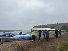 Tynemouth Rowing Club Tynemouth Rowing Club group of people carrying a white boat on the beach